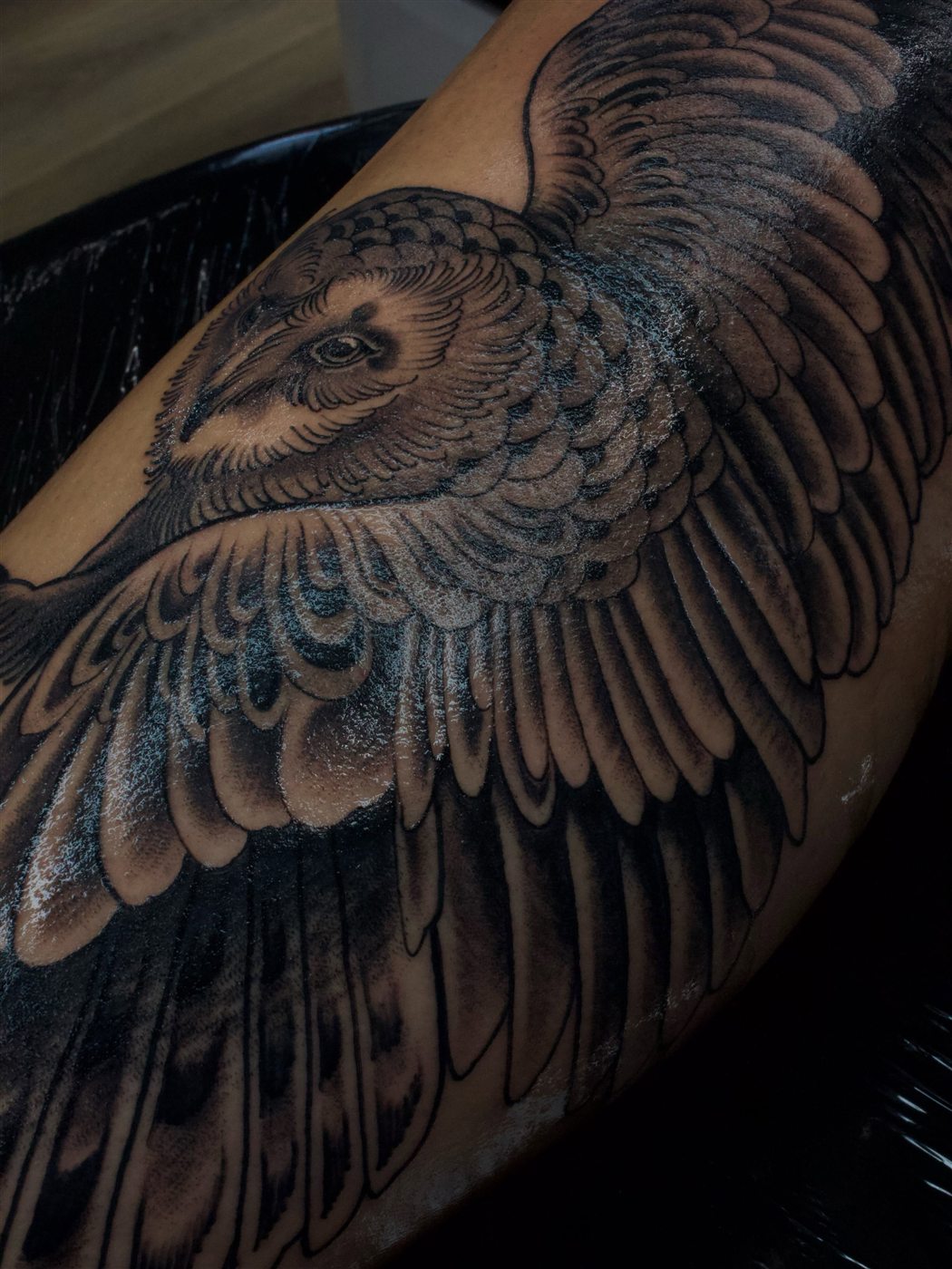 Black and grey owl tattoo on the forearm